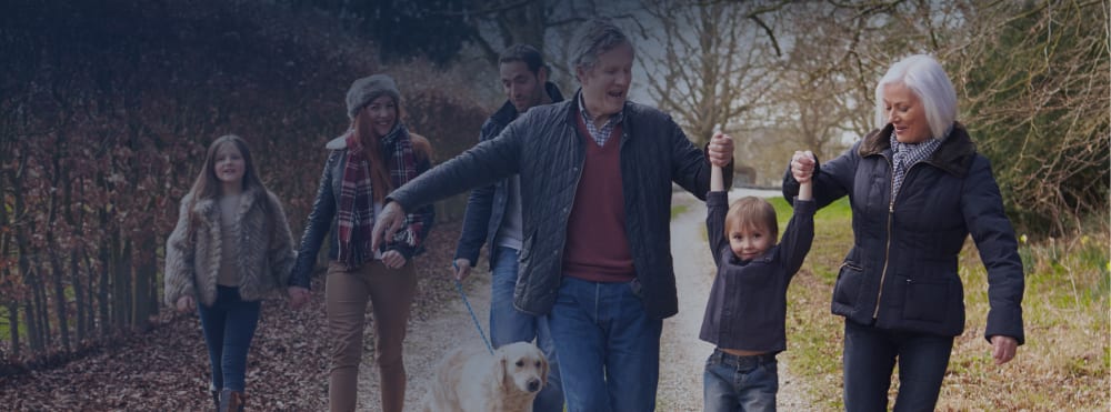A family walks down a path outside.