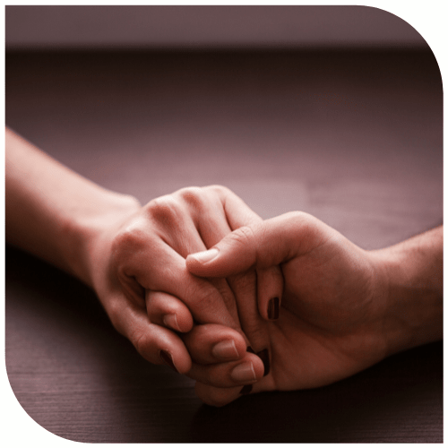 Two people are holding hands.