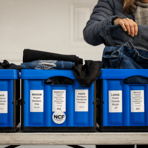 Volunteer sorting clothes at a NCF supported program