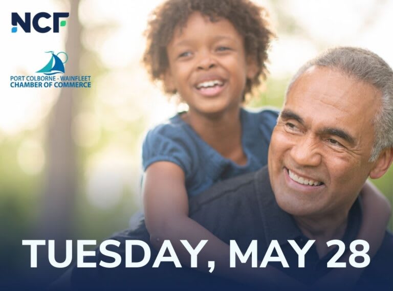 A young boy rides on a man's back and smiles.