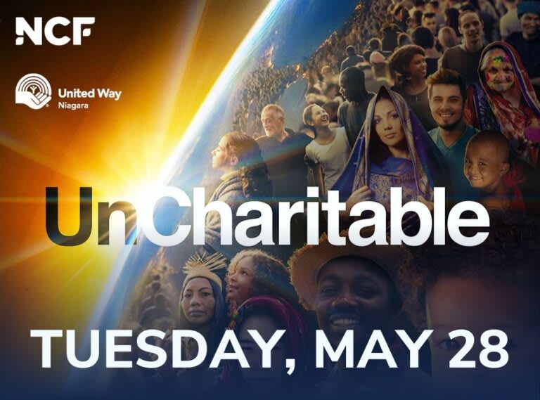 The sun shines from behind the Earth. There is a group of people in front of the planet.