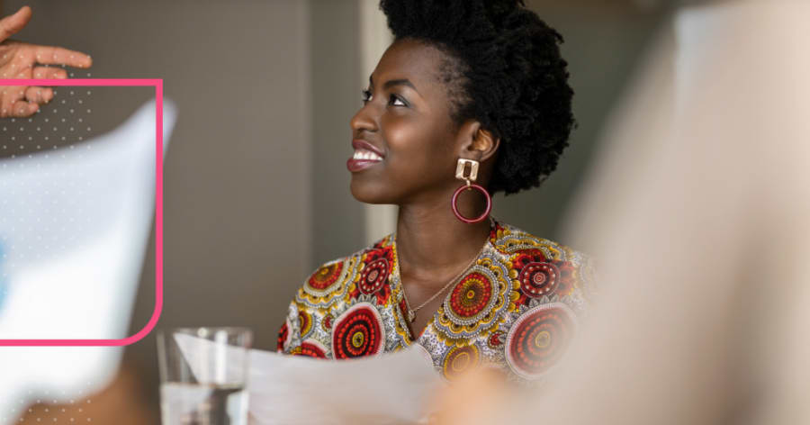 A woman in large hoop earrings is smiling.